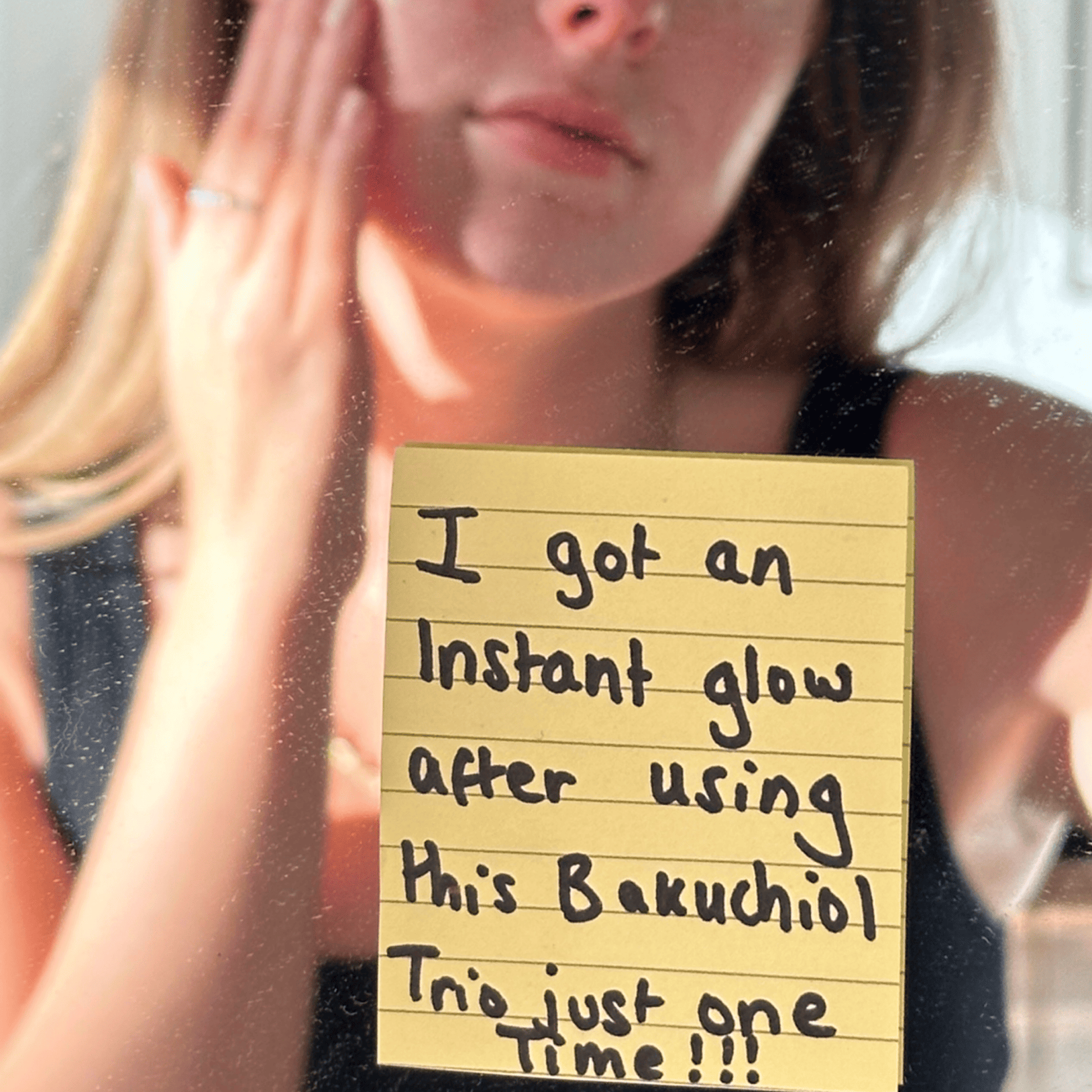 Note on a mirror with text about using Bakuchiol, with a person holding their face.