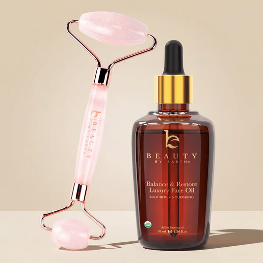 Beauty by Earthy face oil bottle with pink roller on beige background