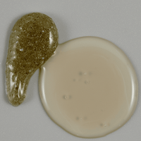 Two blobs of different colored substances on a gray background