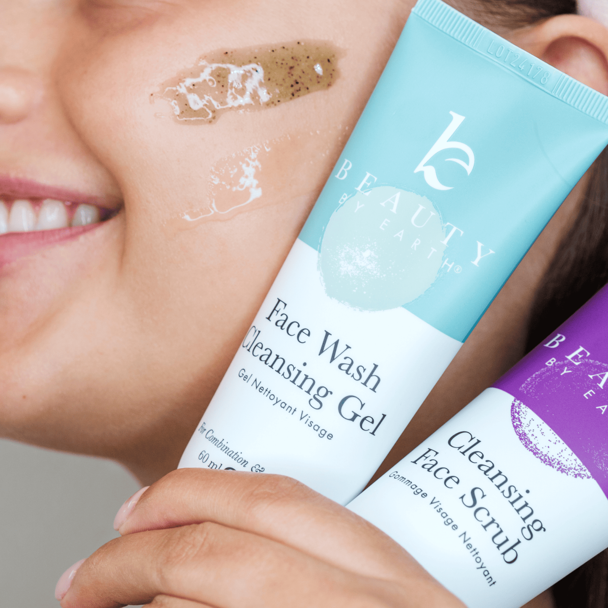 Person holding two skincare products with visible branding