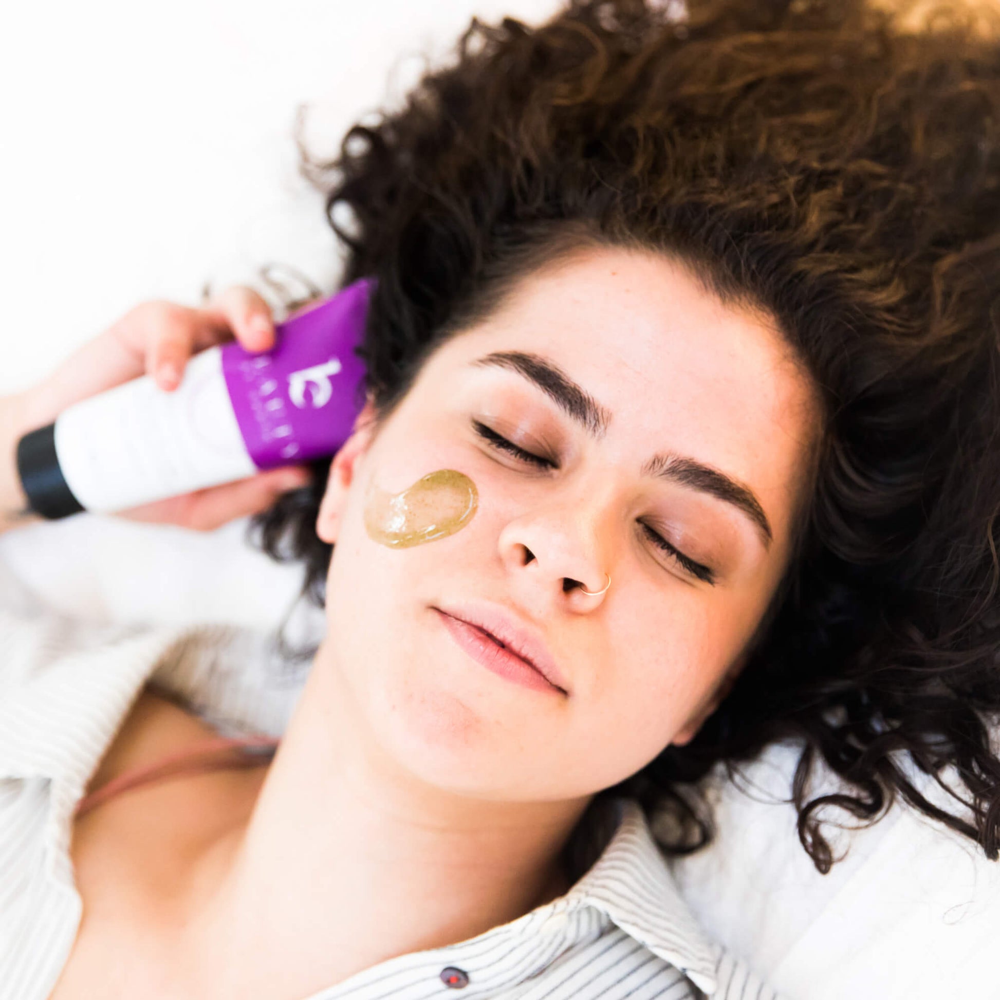 Woman applying a face scrub