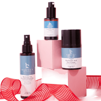 Beauty product set with bottles and a pink box on a white background