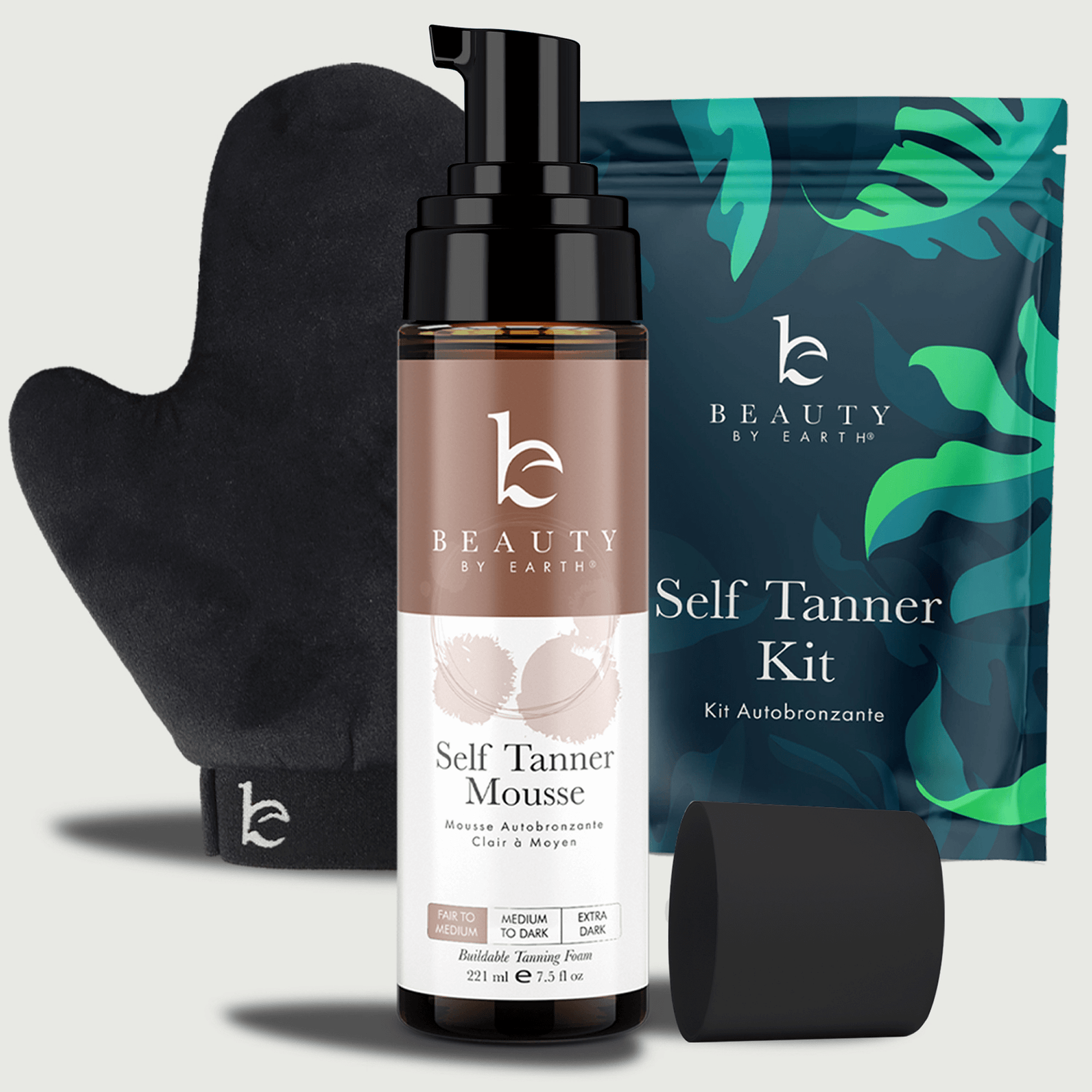 Beauty by Earth self Tanner kit with bottle, mitt, and packaging on a light gray background