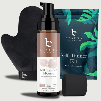 Beauty by Earth self Tanner kit with bottle, mitt, and packaging on a light gray background