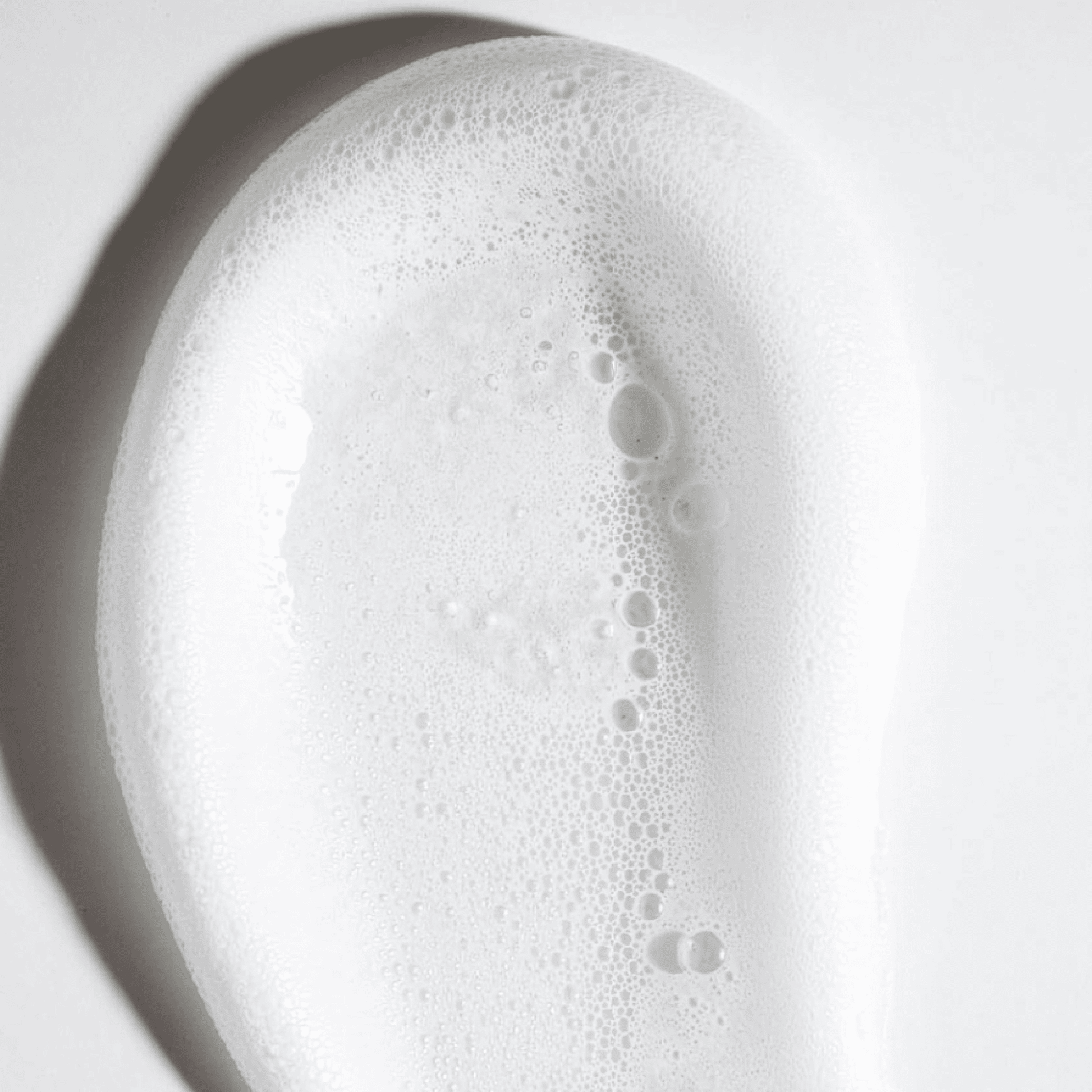 Macro of mousse white foam texture on white background