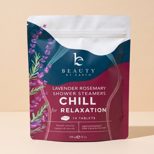 Beauty by Earth Lavender Rosemary Shower Steamers Chill for Relaxation 14 tablet pouch, featuring a dark teal and deep magenta design with lavender illustrations, set against a solid beige background.