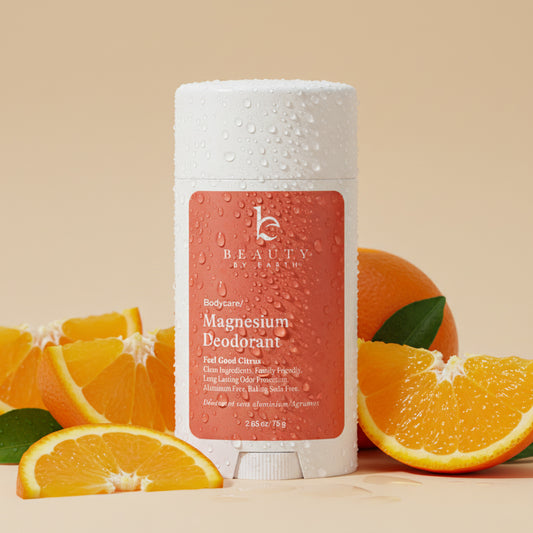 Beauty by earth feel good citrus magnesium deodorant with oranges on a beige background