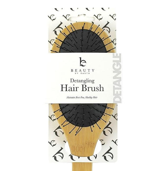 Detangling hair brush packaging with 'Beauty by Earth' branding on a white background