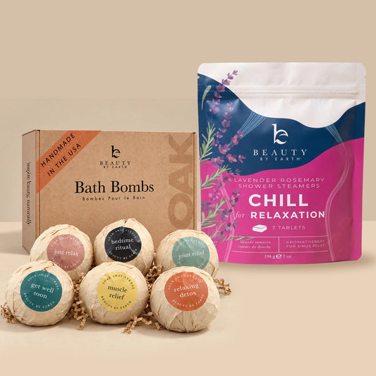 Beauty by Earth Bath Bomb Gift Set featuring six individually wrapped bath bombs alongside a Lavender Rosemary Chill Shower Steamers pouch, displayed against a warm beige background.
