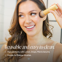 A woman smiling while having product applied with a brush. A hand holds the brush near her cheek, and text at the bottom reads 'Reusable and easy to clean.