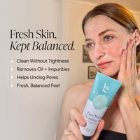 A woman applies a white face wash cream to her cheek while holding a Face Wash Cleansing Gel. The image features promotional text on the left side reading 'Fresh Skin, Kept Balanced.