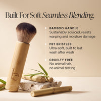 A bamboo makeup brush with soft brown bristles is shown on a warm beige background with marketing text about bamboo handle, PBT bristles, and cruelty-free quality. Bamboo pieces and green leaves are styled around the brush.