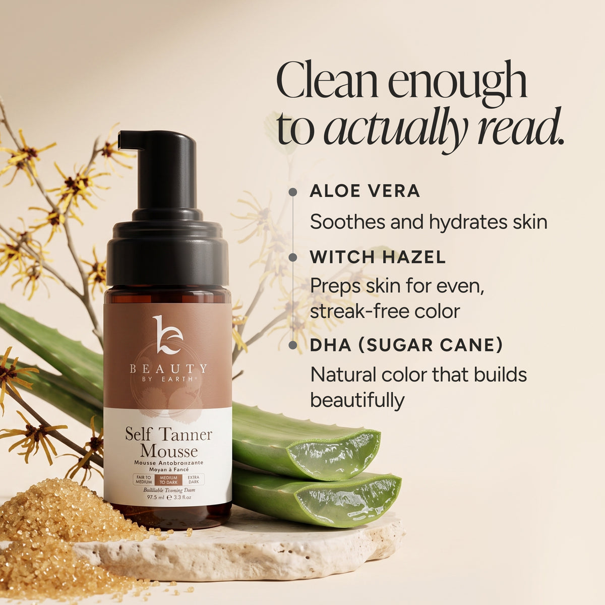 A bottle of Beauty by Earth Self Tanner Mousse shown on a warm beige background with aloe vera leaves and dried flowers. Text on the right lists ingredients: Aloe Vera, Witch Hazel, and DHA (sugar cane).