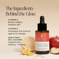 Beauty by Earth Vitamin C Serum in an amber glass dropper bottle with a coral-pink label, shown beside sliced orange, apple pieces, and text highlighting key ingredients on a warm beige background.