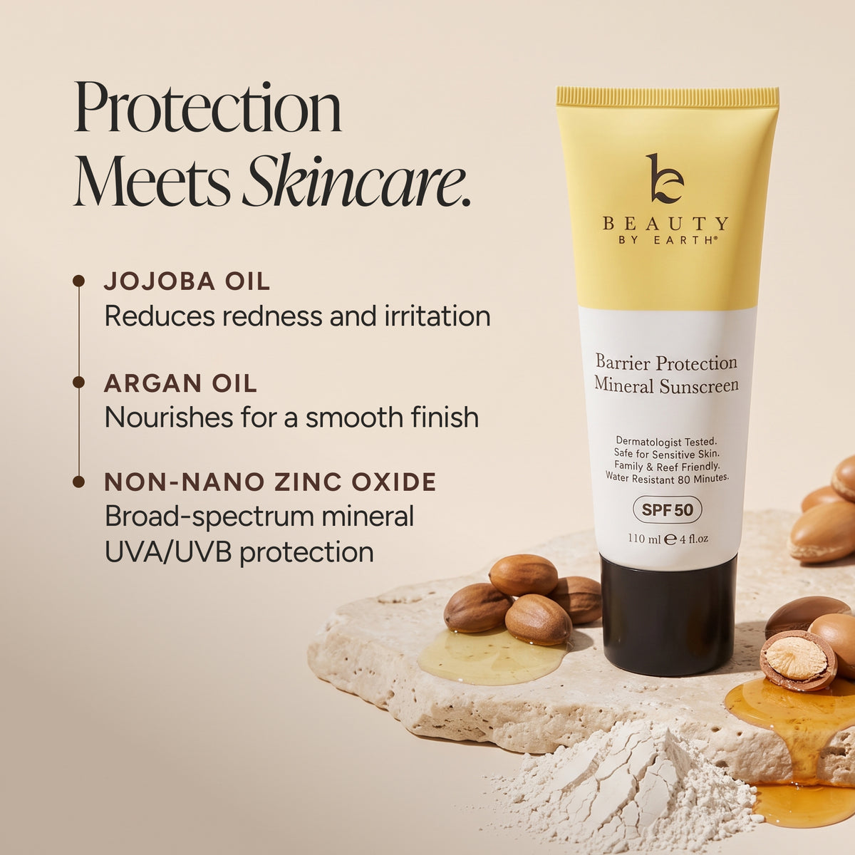 Beauty by Earth Barrier Protection Mineral Sunscreen SPF 50 in a yellow and white squeeze tube, displayed on a beige background with jojoba oil, argan nuts, and powder.