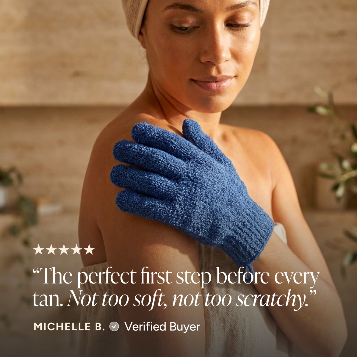 A woman wrapped in a towel wears a blue textured exfoliating glove on her shoulder in a warm spa-like setting. A quote from Michelle B.
