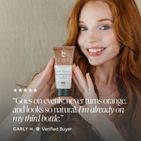 A smiling woman with red hair holds a tube of Beauty by Earth Self Tamer in front of her face. The image includes a five-star rating and a customer quote from Carly H.