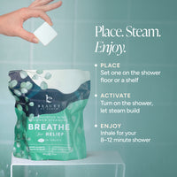 A hand holds a white square steam packet above a stand-up pouch of Beauty by Earth Breathe for Relief mini shower steam tablets. The pouch is teal and dark blue with white text and leaf graphics.