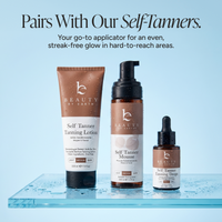 Three Beauty by Earth self-tanning products arranged on a clear glass tray against a light blue background: a tube of Self Tanner Tanning Lotion, a pump bottle of Self Tanner Mousse, and a dropper bottle of Self Tanner Tanning Drop. Text at the top reads, 'Pairs With Our SelfTanners.