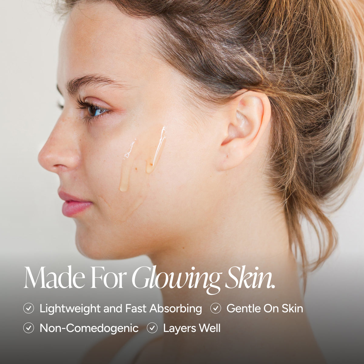 Close-up side profile of a woman with a small amount of serum applied to her cheek, with marketing text reading 'Made For Glowing Skin' and feature bullet points below on a soft light gray background.