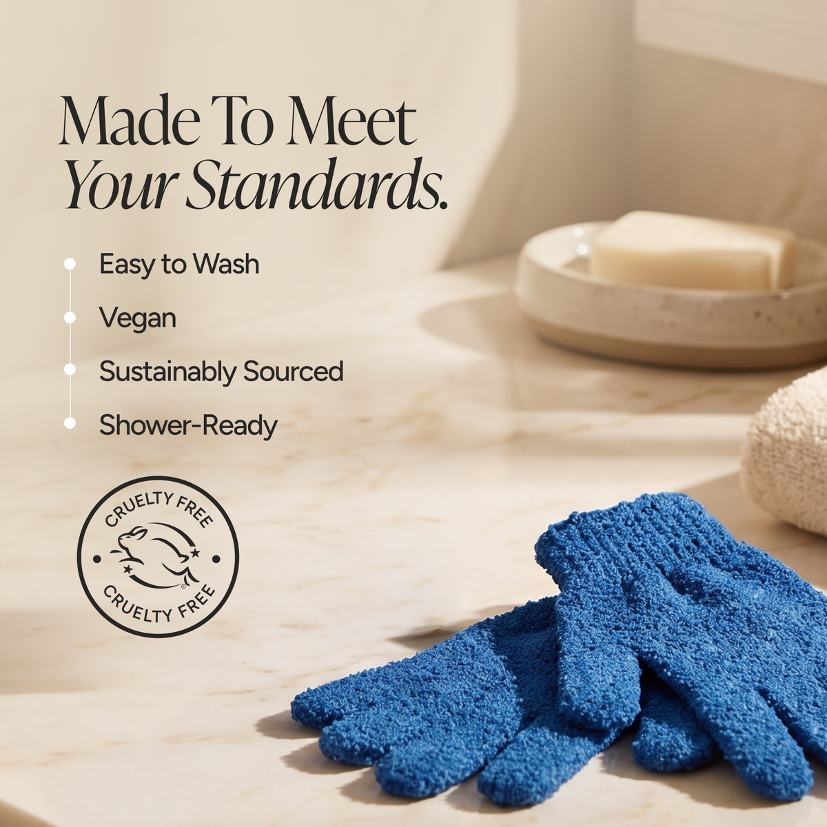 Blue textured shower gloves on a marble surface with promotional text reading 'Made To Meet Your Standards' and feature callouts including Easy to Wash, Vegan, Sustainably Sourced, and Shower-Ready. A circular cruelty-free seal is also shown.