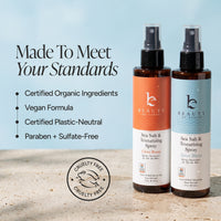 Two bottles of Beauty by Earth Sea Salt & Texturizing Spray shown on a sandy surface against a light blue background, with marketing text and a cruelty-free seal on the left.