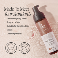 A bottle of BEAUTY BY EARTH Self Tanner Mousse in shade Medium, shown on a textured beige background with water ripples