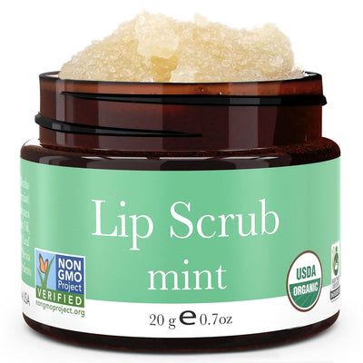 Lip scrub jar with green label on a white background