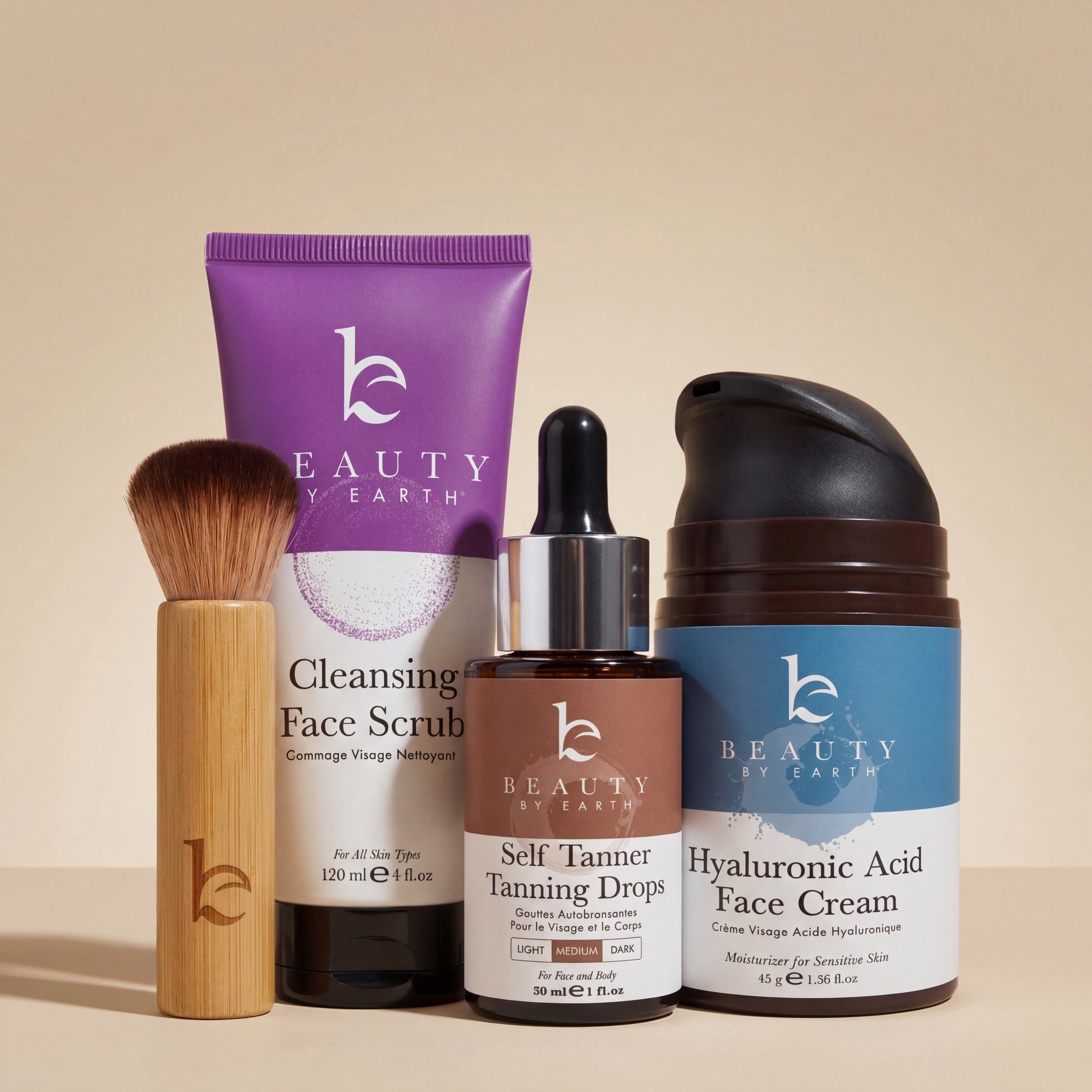 Collection of Beauty by Earth skincare products including scrub, drops, cream, and brush on a beige background.