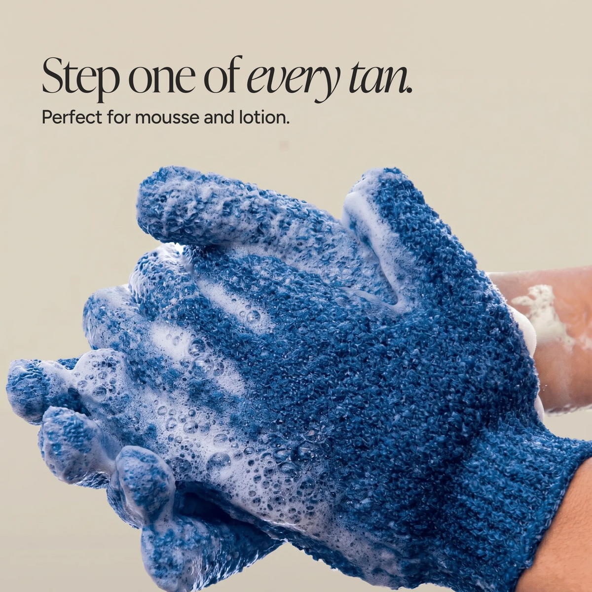 A pair of exfoliating gloves being washed.
