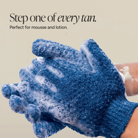 A pair of exfoliating gloves being washed.