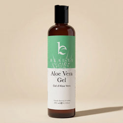 Bottle of Aloe Vera Gel with a green label on a beige background