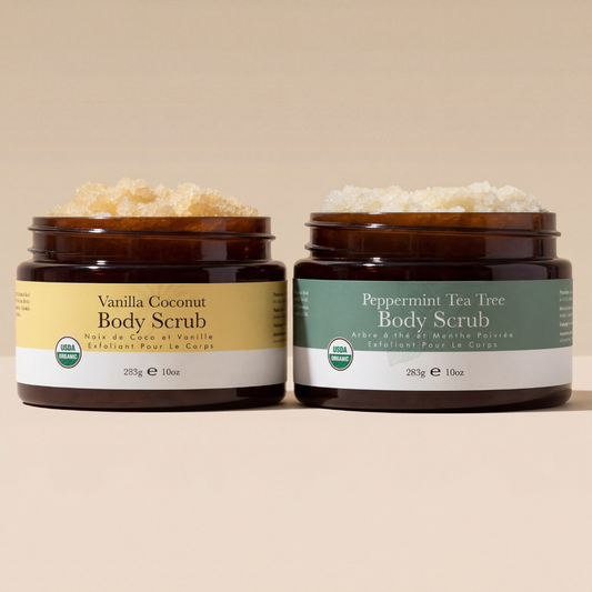 Two jars of Vanilla Coconut and Peppermint Tea Tree body scrubs on a beige background
