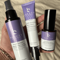 Three skincare products from Beauty by Earth held in a hand against a neutral background