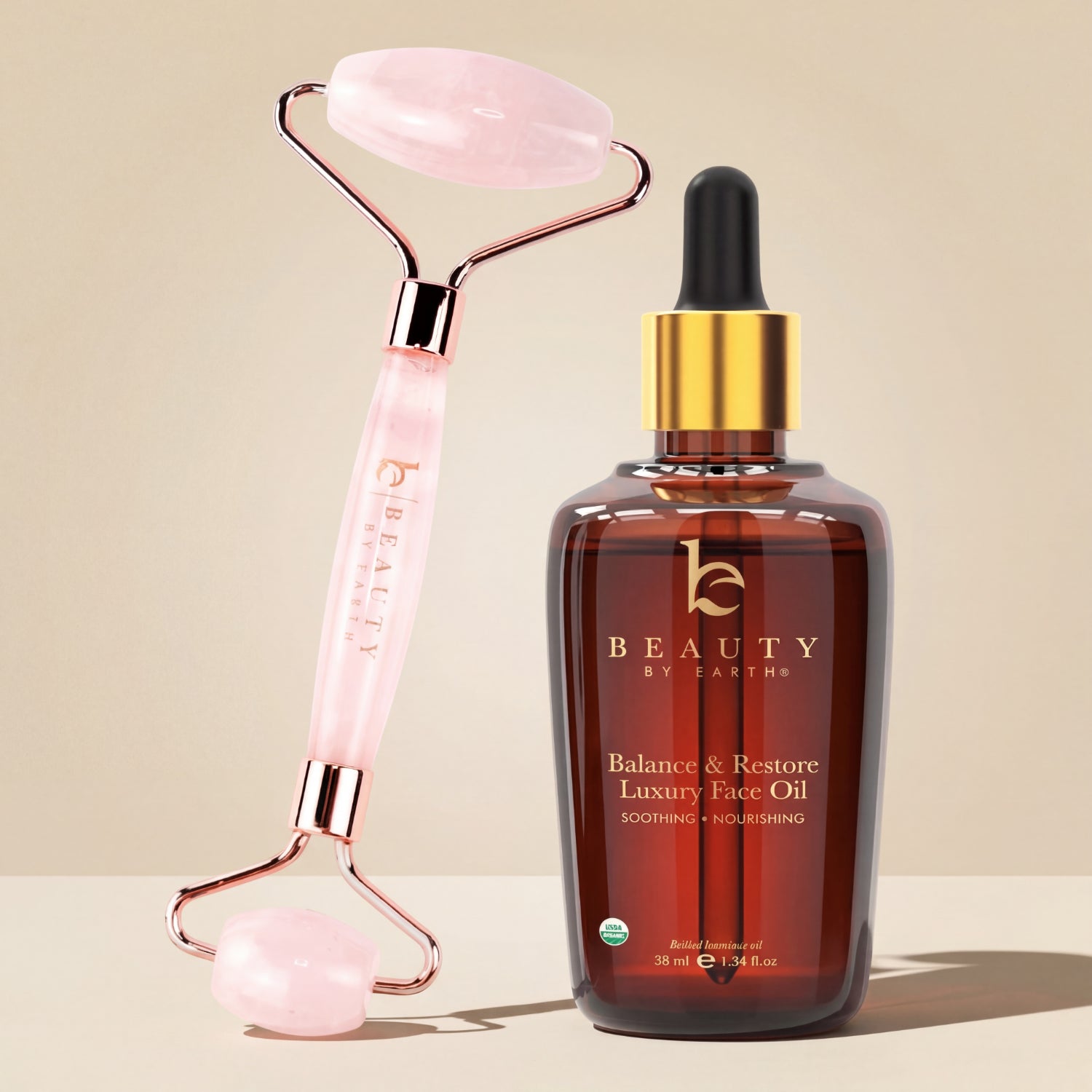 Beauty by Earthy face oil bottle with pink roller on beige background