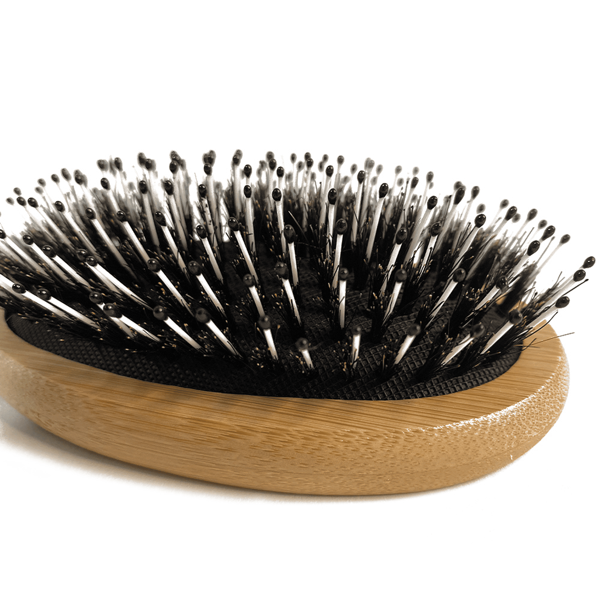 Hairbrush with wooden handle and black bristles on a white background