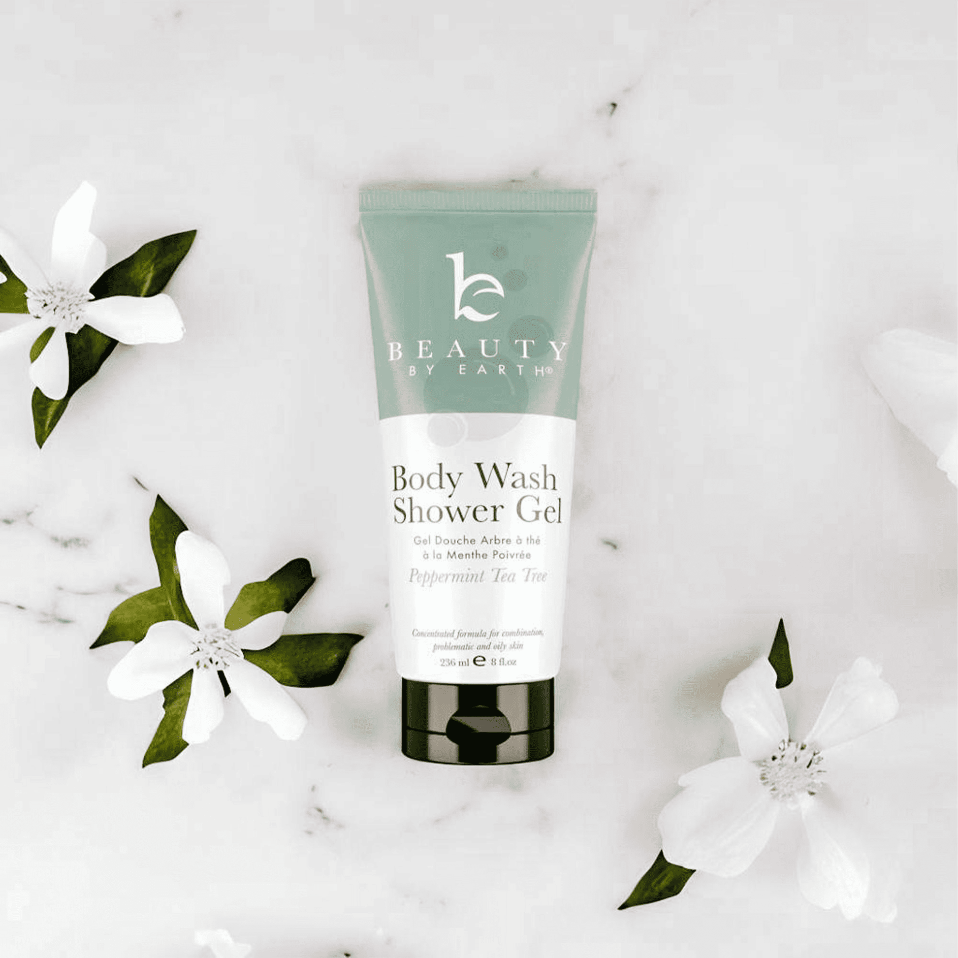 Body wash shower gel peppermint tea tree tube with flowers on a light background