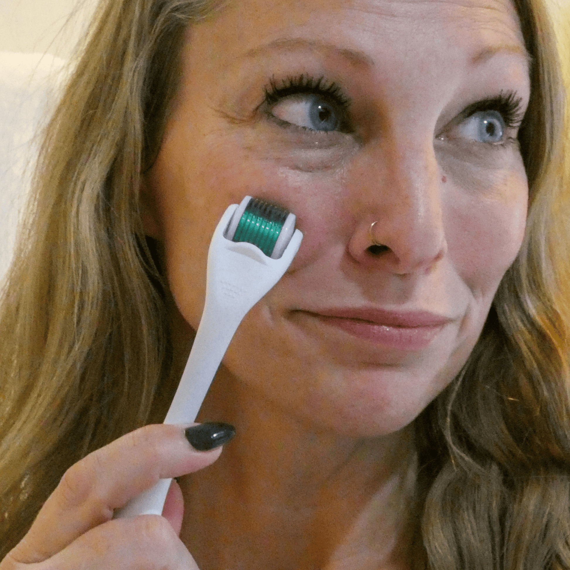 Woman using a derma roller on her face