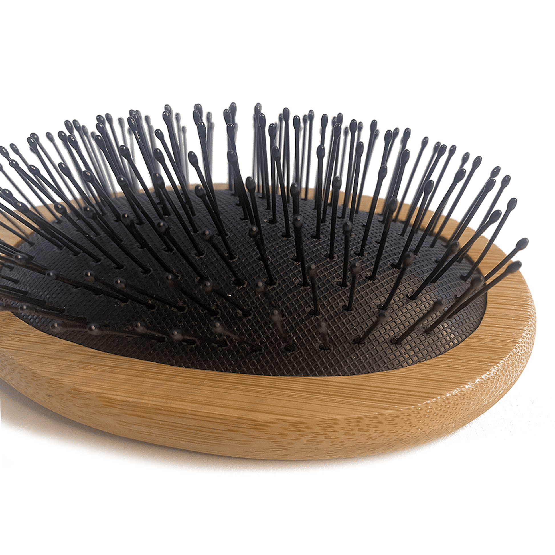 Hairbrush with black bristles on a wooden handle against a white background