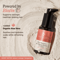 Dry shampoo and volume powder bottle with text about Biotin and Aloe Vera on a textured background