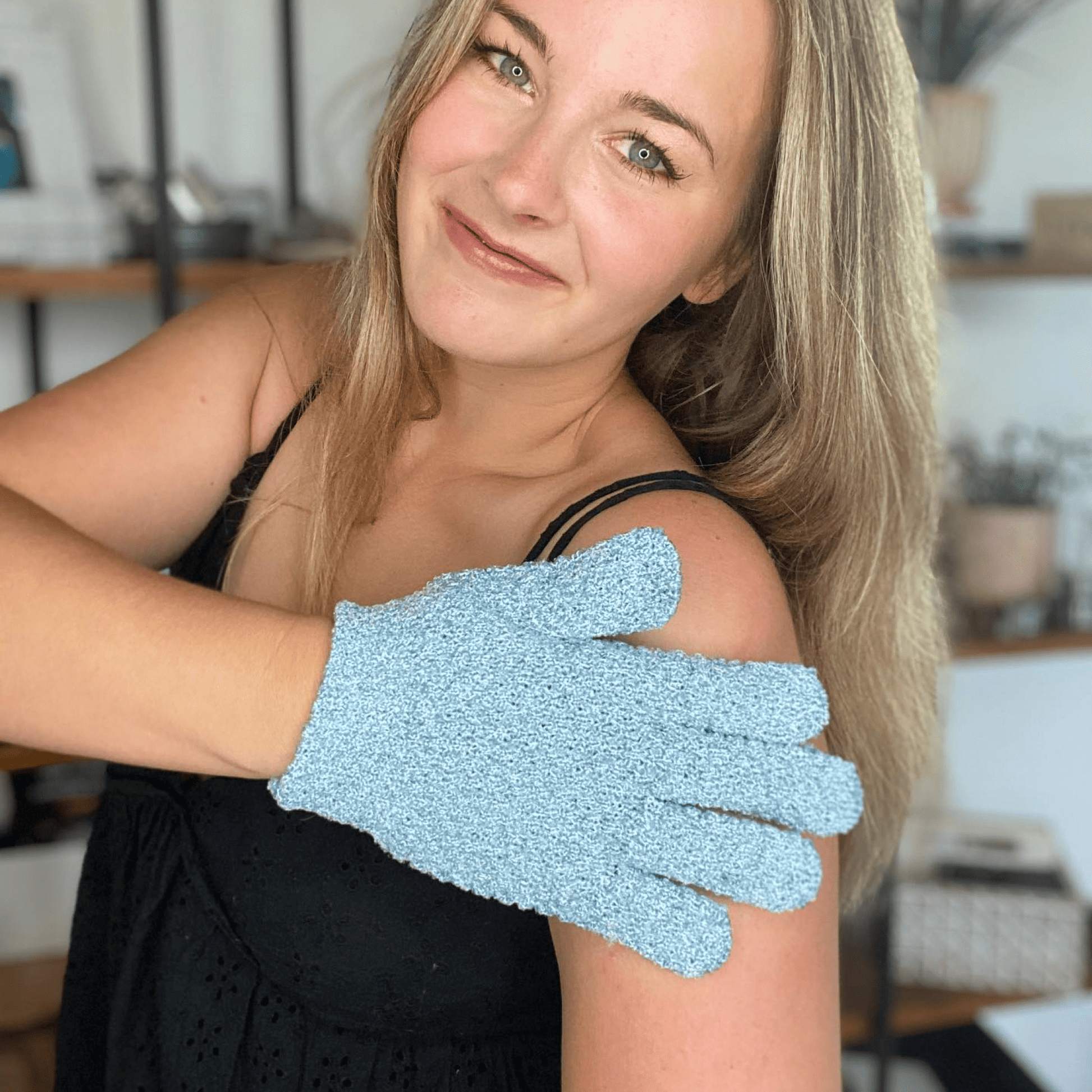 Woman using the heavy exfoliating glove on her arm with blurry background