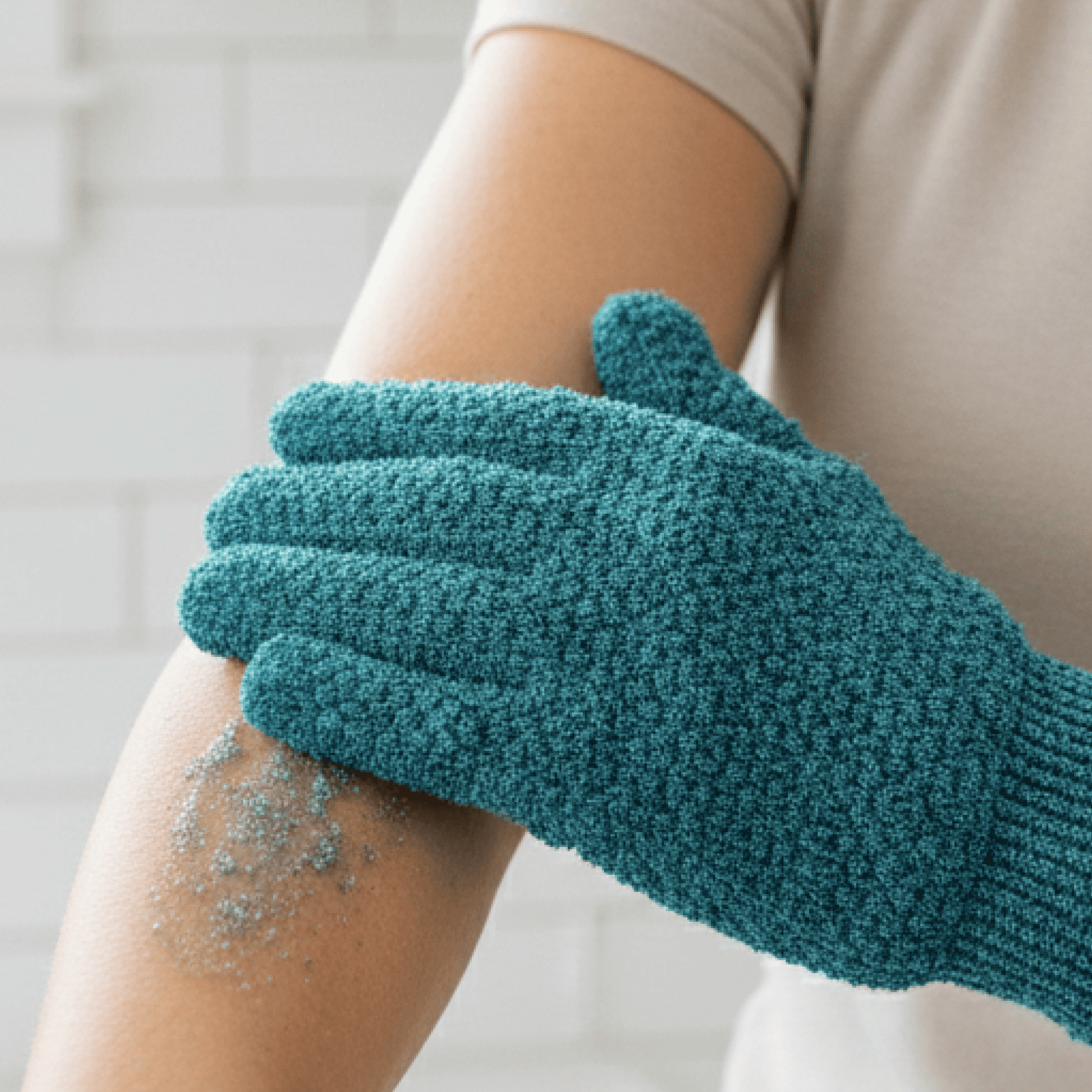 Medium exfoliating glove being used on a person's arm with exfoliating scrub visible.
