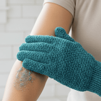 Medium exfoliating glove being used on a person's arm with exfoliating scrub visible.