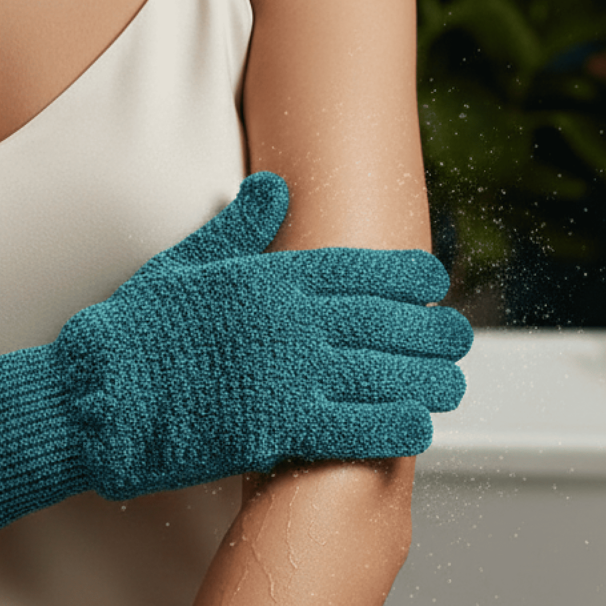 Exfoliating medium glove being used on a person's arm with a blurred background