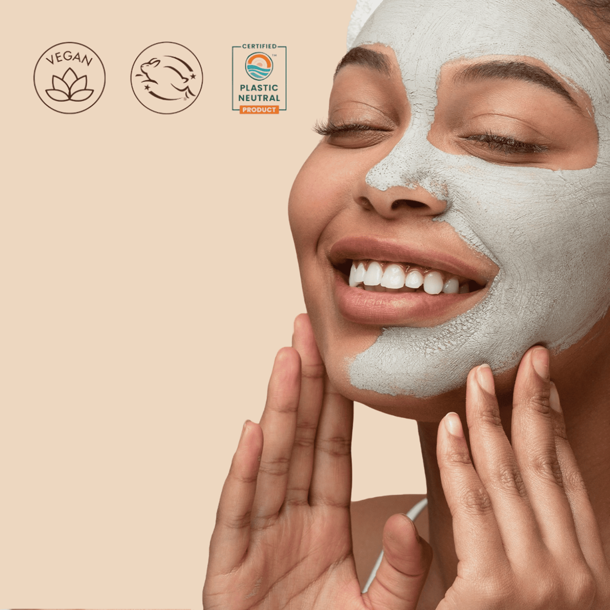 Woman applying clay face mask on face and badges showing vegan, bunny certified and plastic neutral product.
