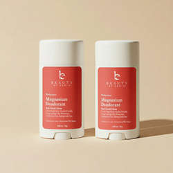 Two Beauty by Earth magnesium deodorants on a beige background