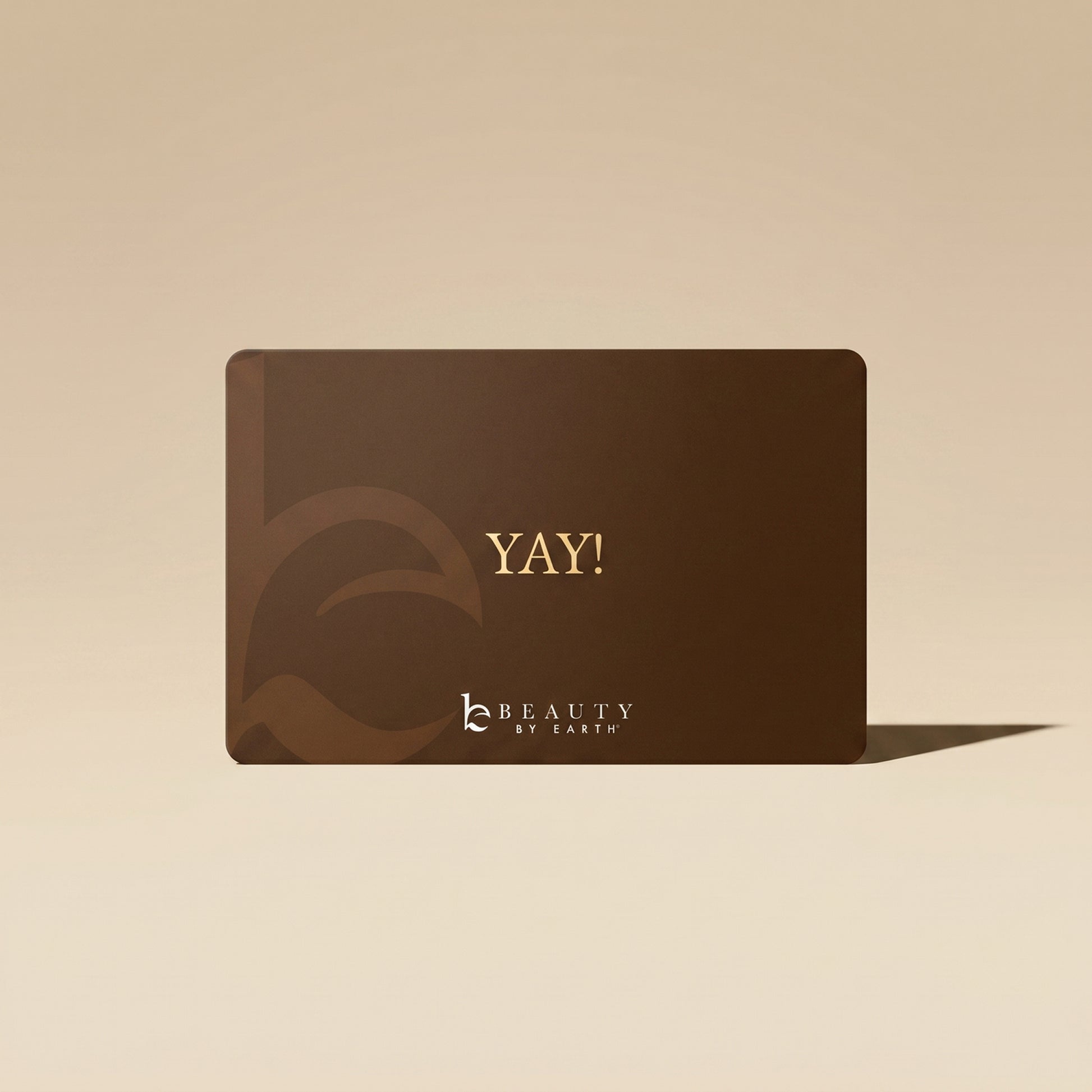 Brown gift card with 'YAY!' text and brand logo on a beige background