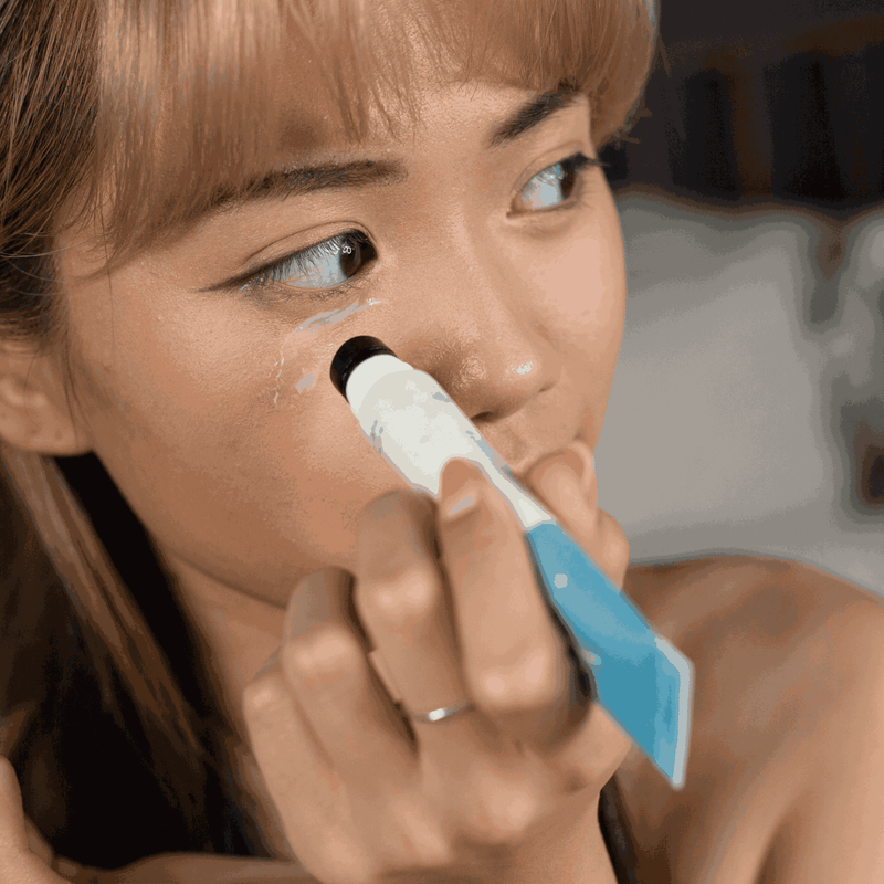 Woman applying gel on her face