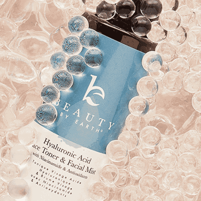 Beauty by Earth product packaging surrounded by bubbles on a textured background