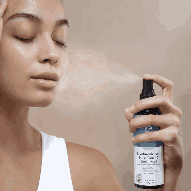 Person using a bottle of Hyaluronic Acid Face Toner & Facial Mist on their face.